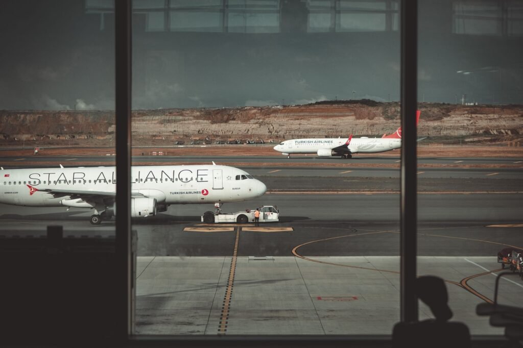View from an airport terminal of jets on a desert runway